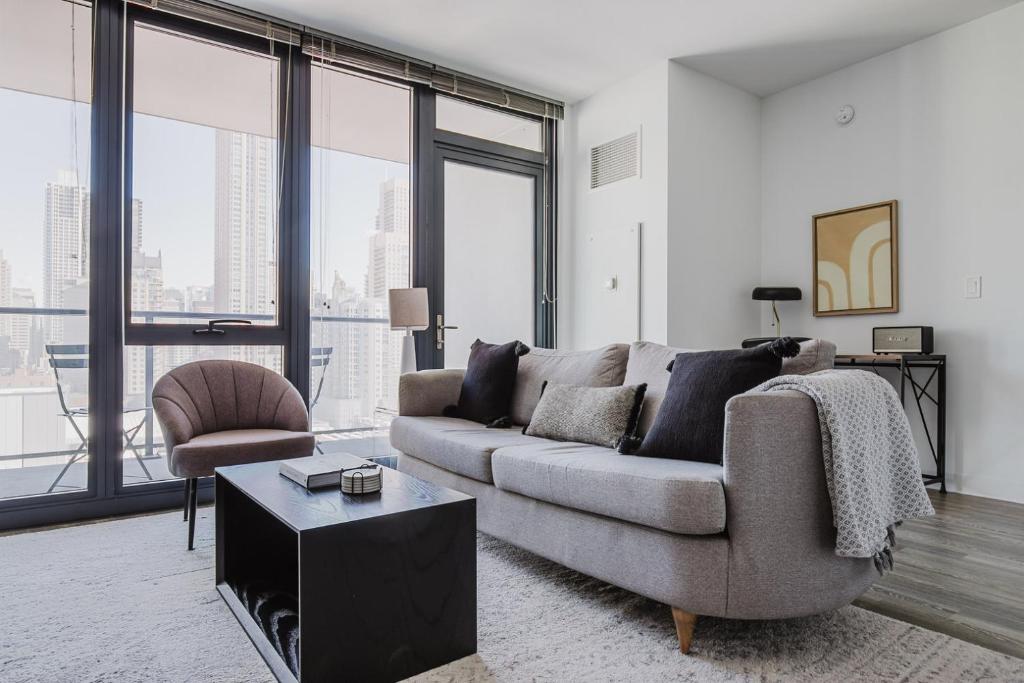 a living room with a couch and a chair at Blueground River North pool AC nr park CHI-1193 in Chicago