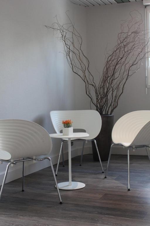 two chairs and a table in a room at B&B HOTEL La Rochelle Centre in La Rochelle