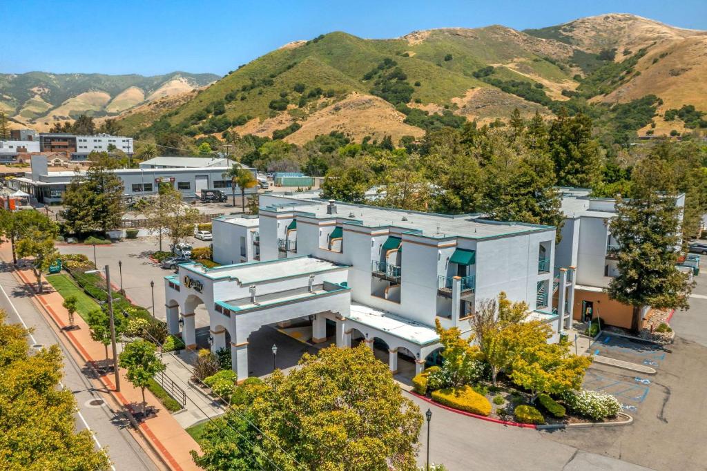 an aerial view of a building with mountains in the background at Quality Suites Downtown San Luis Obispo in San Luis Obispo