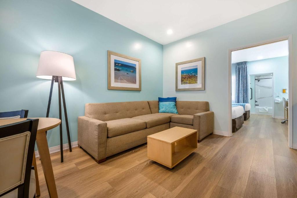 a living room with a couch and a bed at Quality Suites Downtown San Luis Obispo in San Luis Obispo