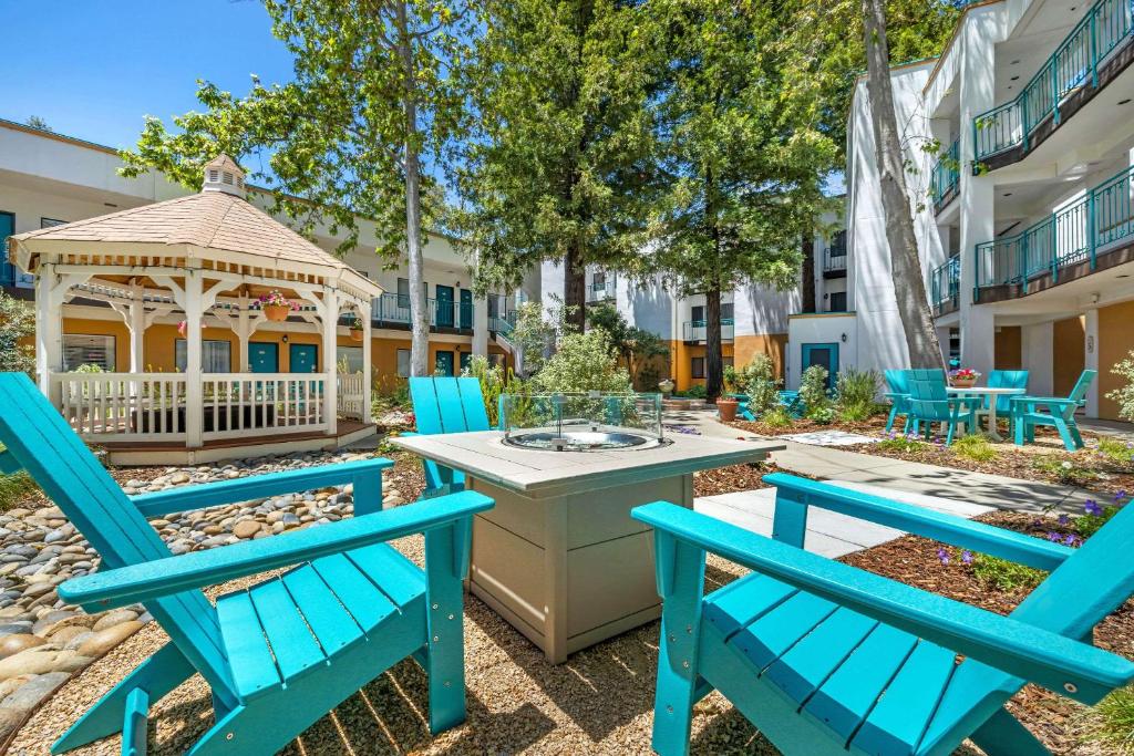 a patio with blue chairs and a gazebo at Quality Suites Downtown San Luis Obispo in San Luis Obispo