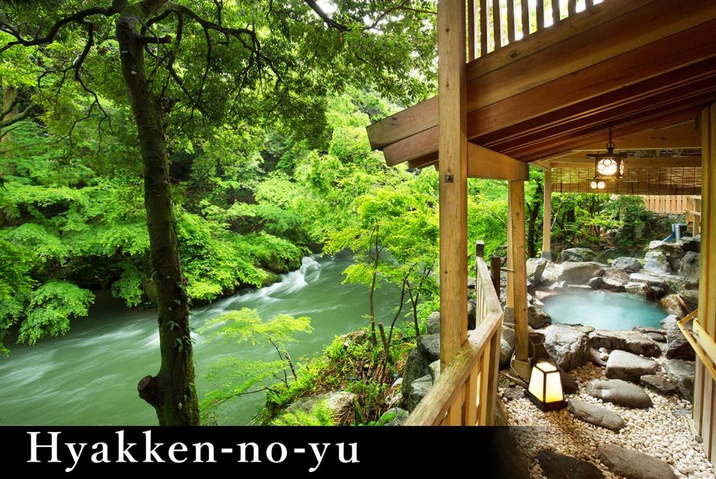 a view of a river from a cabin with a waterfall at Yamanaka Onsen Kagari Kisshotei in Kaga