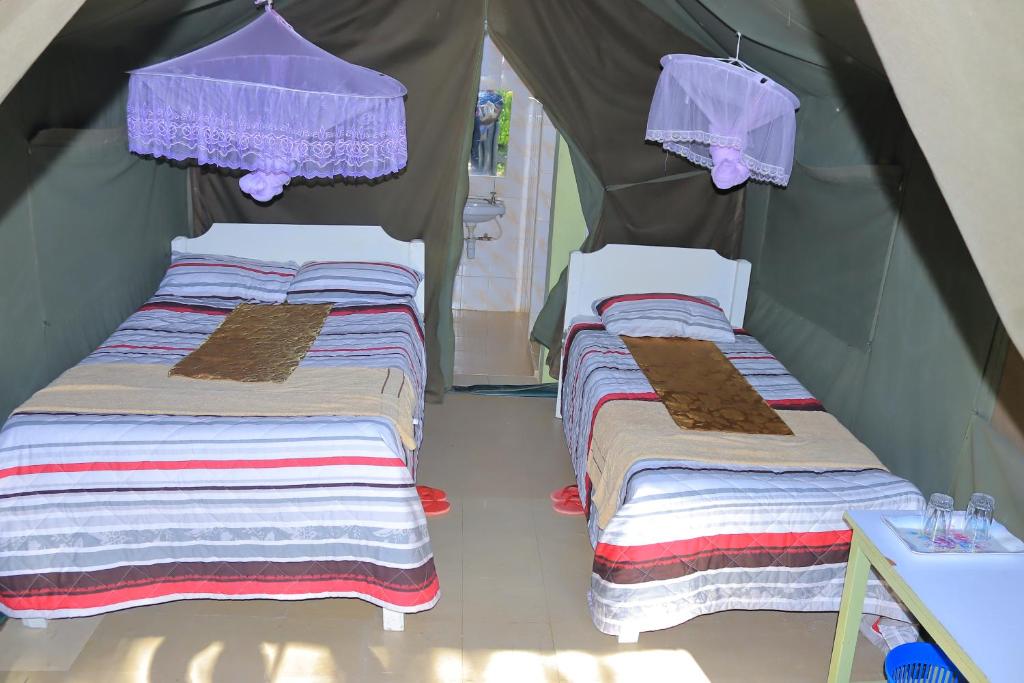 Postel nebo postele na pokoji v ubytování Rhino Tourist Camp