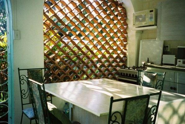 a kitchen with a table and a wall of wine bottles at The Legend Garden Condos in Saint Peter