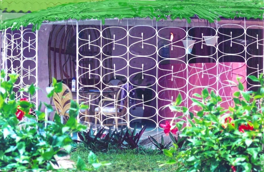 a fence with plants in front of a garden at The Legend Garden Condos in Saint Peter