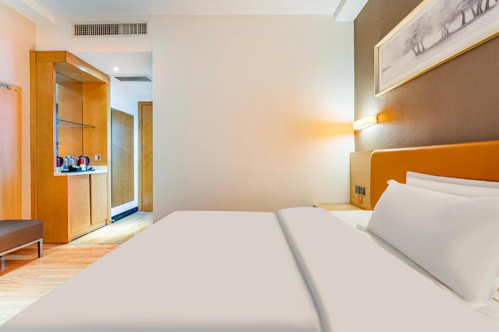 Postel nebo postele na pokoji v ubytování Yunli Boutique Hotel