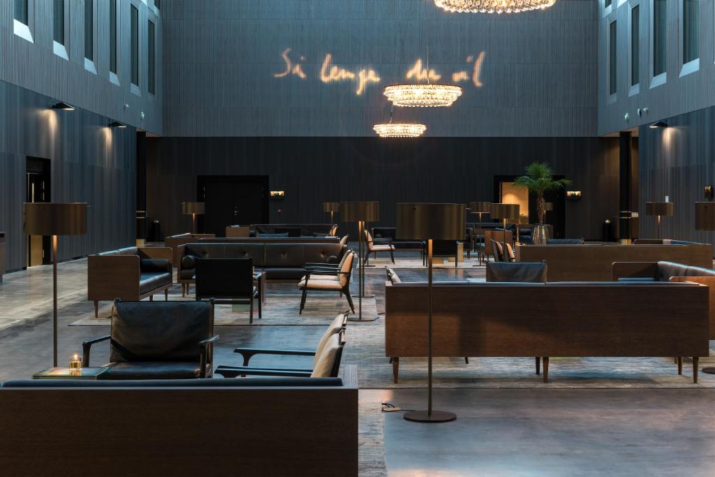 a lobby with chairs and tables in a building at Clarion Hotel Air in Sola