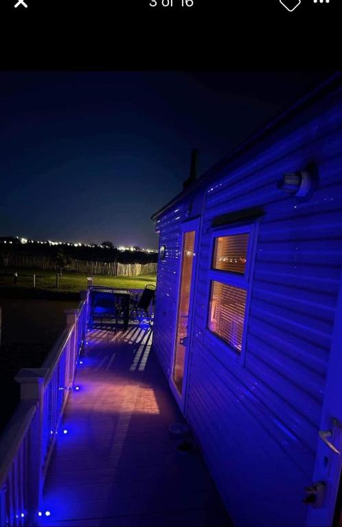 a building with blue lights on the side of it at 8 Berth 3 bed caravan Golden palm ML9 in Chapel Saint Leonards