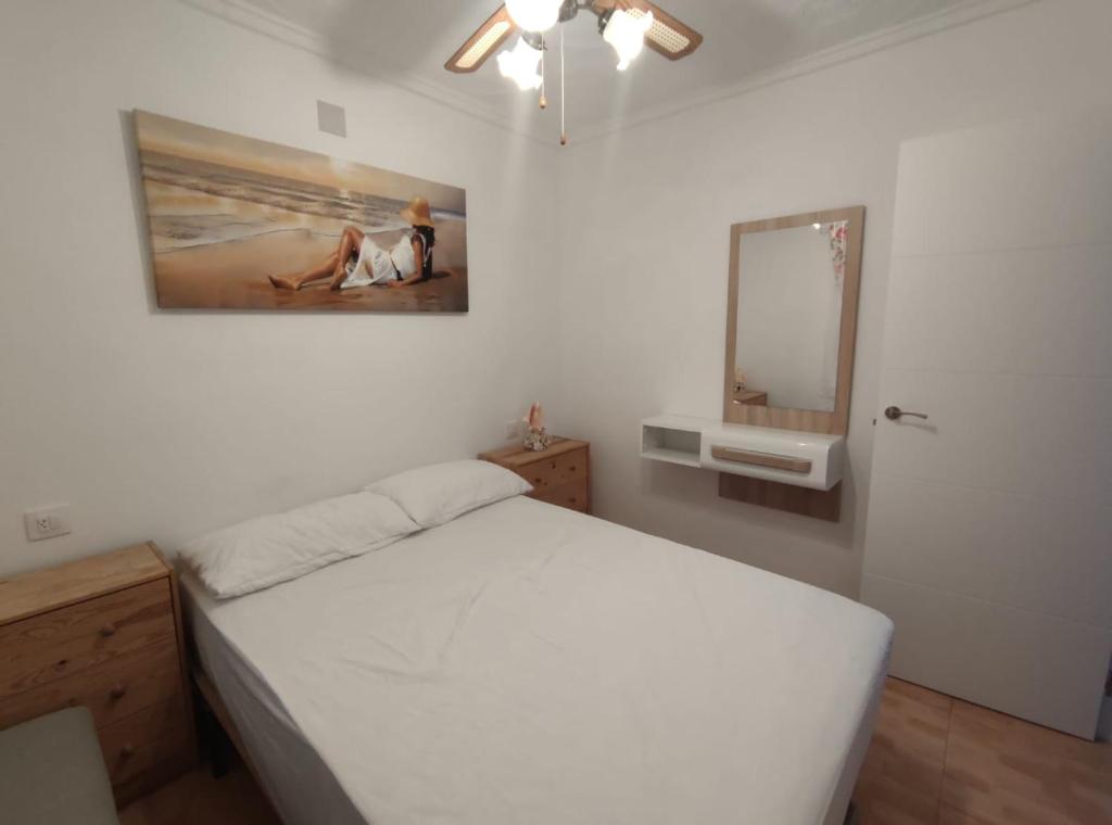 a bedroom with a bed and a painting on the wall at Espanhouse Diana bungalow in La Mata