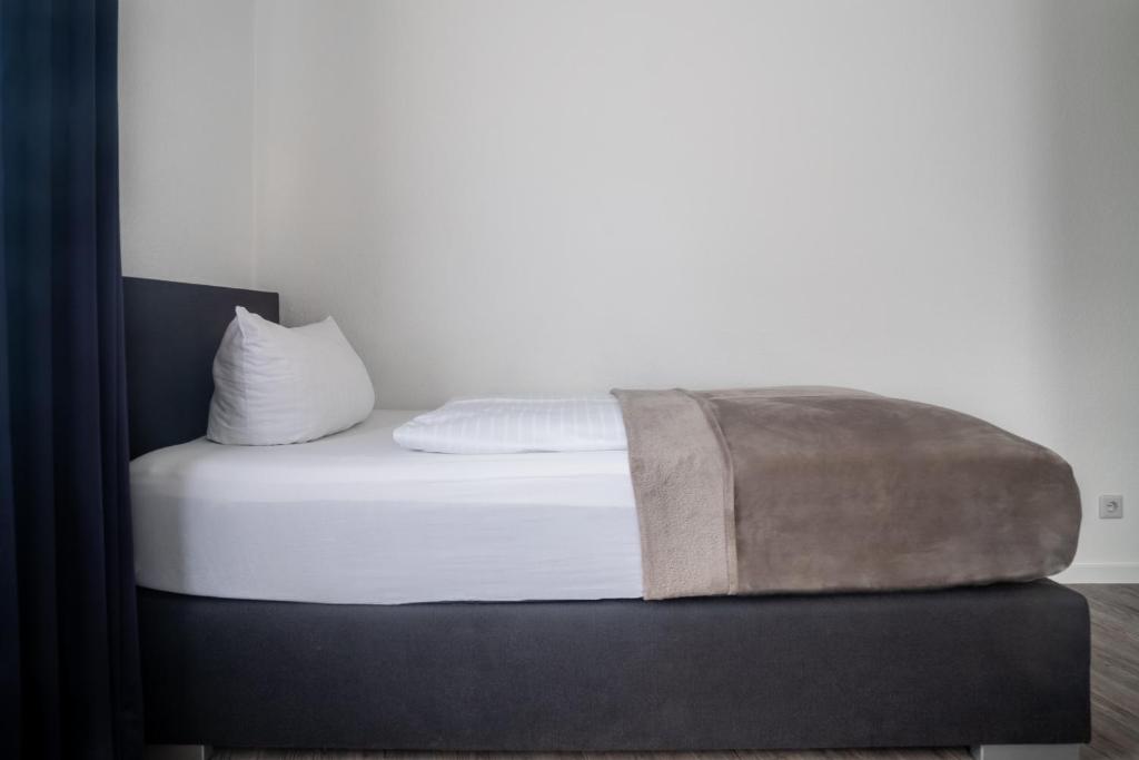 Postel nebo postele na pokoji v ubytování Appart-Haus Business Apartments