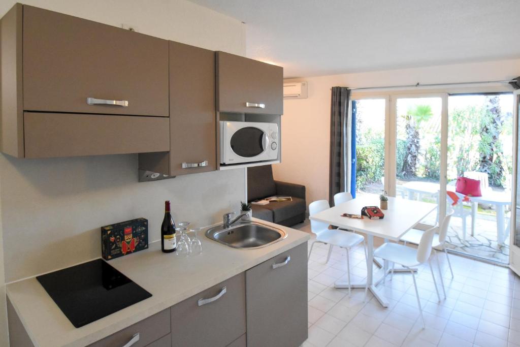 Kuchyň nebo kuchyňský kout v ubytování Residence La Palmeraie