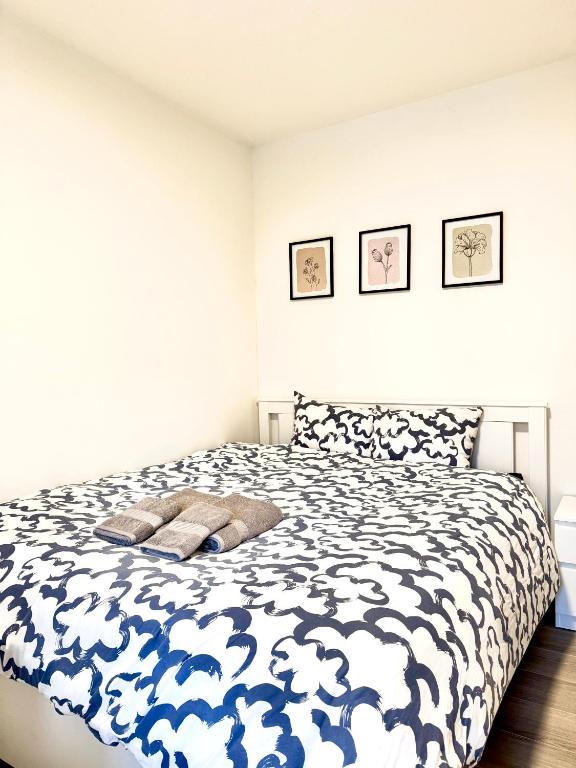 a bedroom with a bed with a blue and white comforter at Free Parking Private ROOM with Balcony, 10mins to Helsinki center in Helsinki