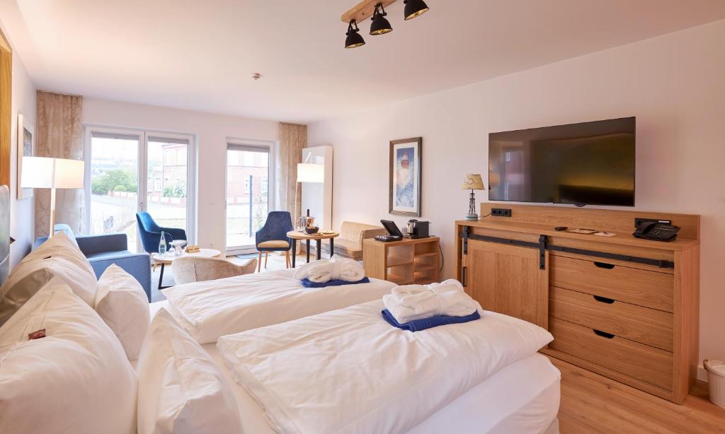 TV a/nebo společenská místnost v ubytování Hotel Villa Düne