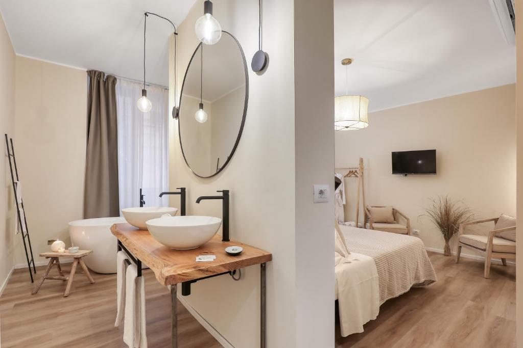 Postel nebo postele na pokoji v ubytování Welchome - Suites
