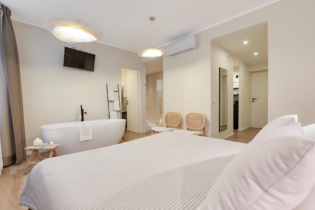 Postel nebo postele na pokoji v ubytování Welchome - Suites