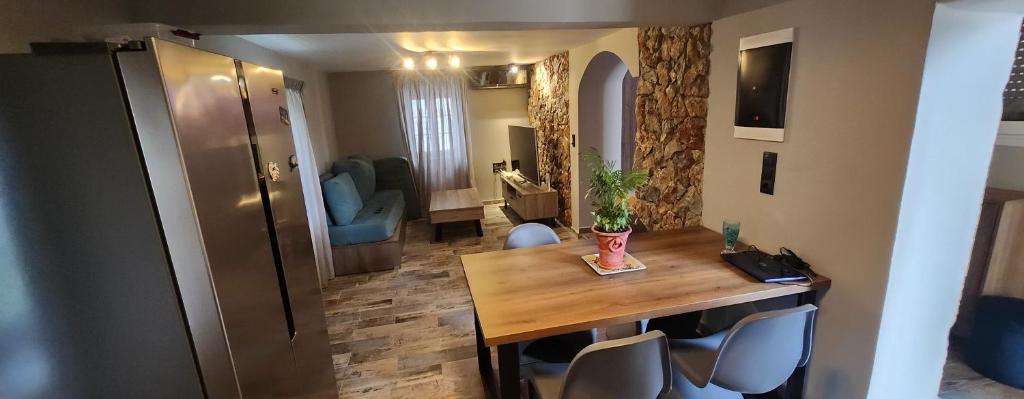 a dining room with a wooden table and chairs at Oinos Luxury apartment in Faliraki