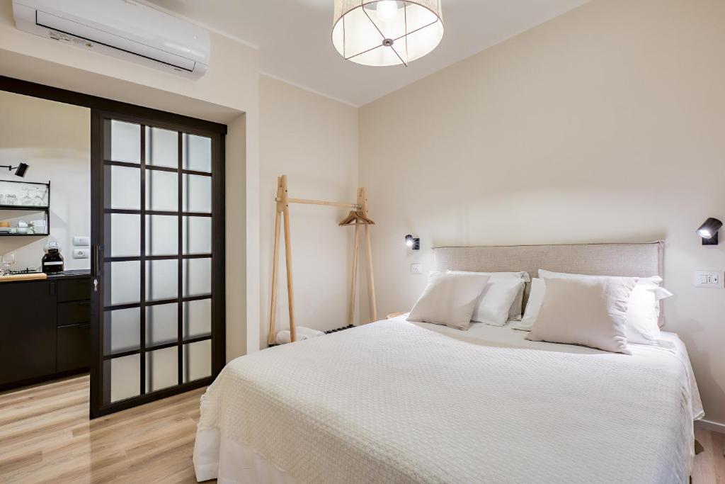 Postel nebo postele na pokoji v ubytování Welchome - Suites