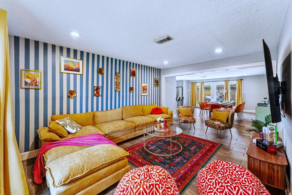 a living room with a couch and a table at Friends-Themed 4BD - Pingpong & Outdoor Theater in Houston