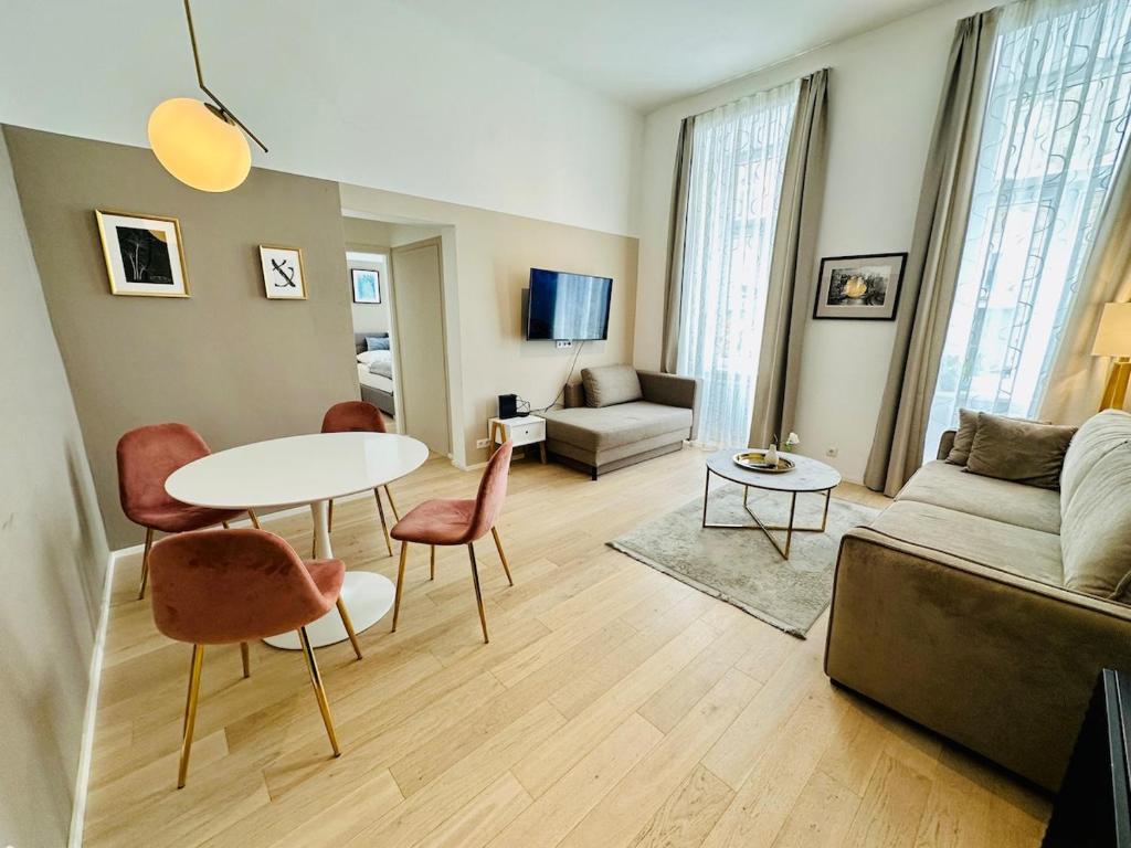 a living room with a table and chairs and a couch at Panda Apartment in Vienna