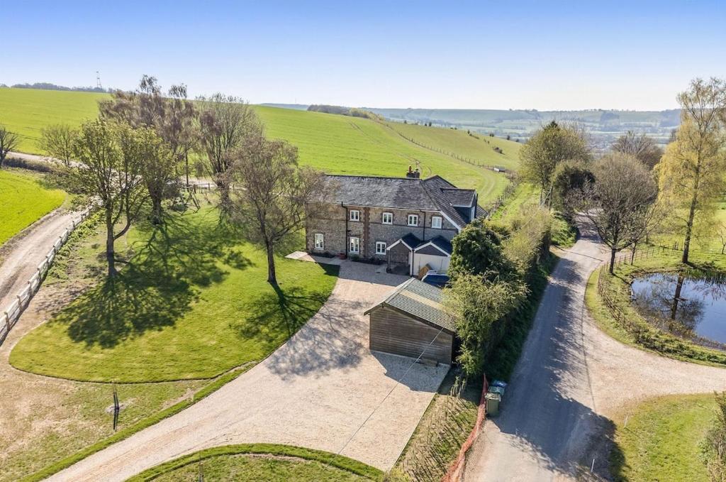 an overhead view of an old house with a driveway at Countryside Home 5 Bed South Downs East Meon House in Petersfield
