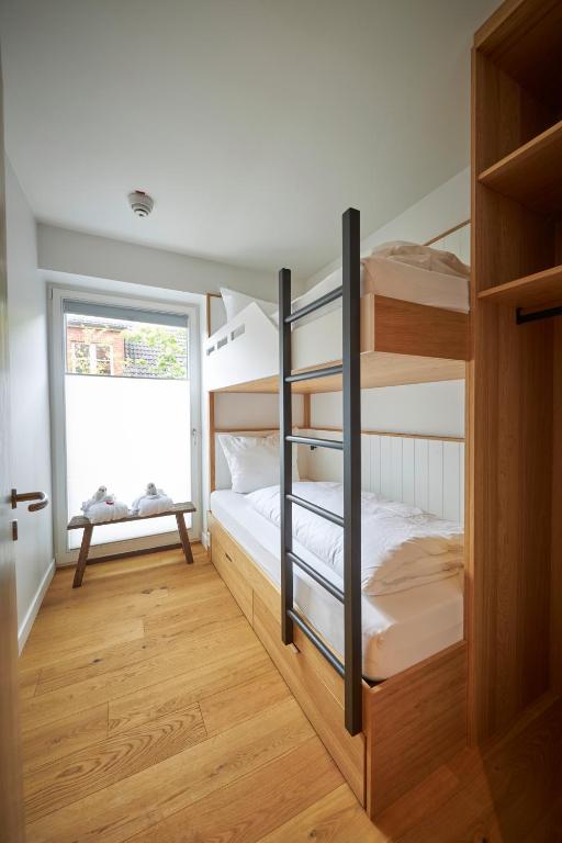Postel nebo postele na pokoji v ubytování Hotel Villa Düne