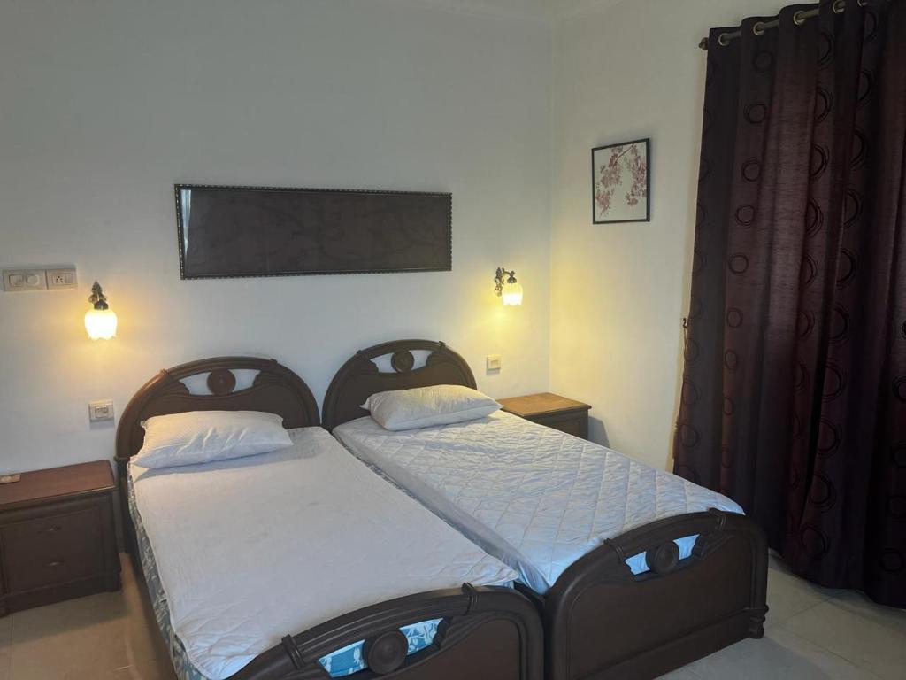 a bedroom with a bed with two pillows on it at Serene villa In North Goa in Arpora
