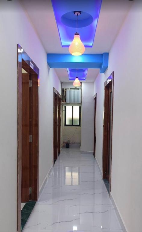 an empty hallway with a blue ceiling and a corridor at Hotel CBD in Navi Mumbai
