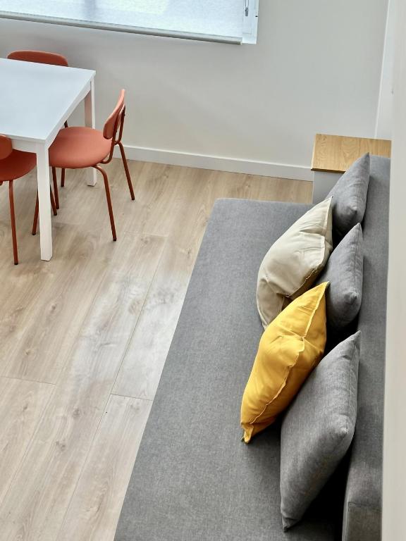 a living room with a couch and a table at Apartamentos Noviembre in Madrid