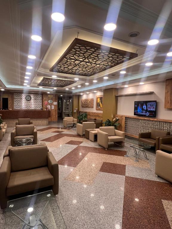 a lobby with couches and a tv in a building at SEFA HOTEL 1 ÇORLU in Corlu