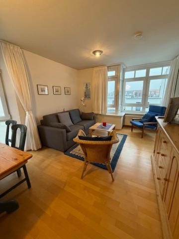a living room with a couch and a table at Ferienwohnungen Alte Schmiede 9 in Norderney