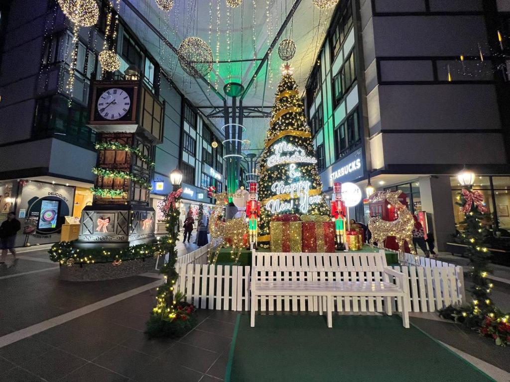 a shopping mall with a christmas tree and a clock at 2B2R at Kae Farm in Brinchang