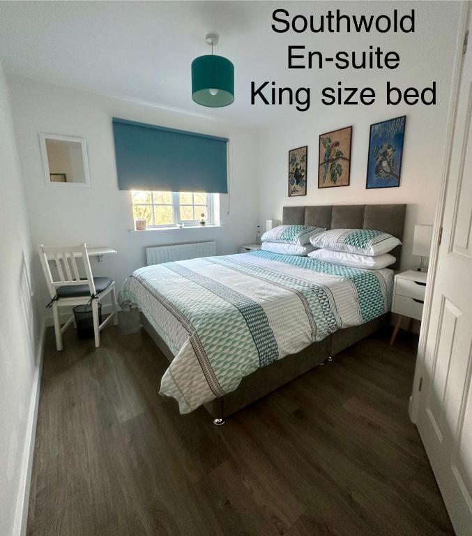a bedroom with a bed with a king size bed at Chez Ana in Saxmundham