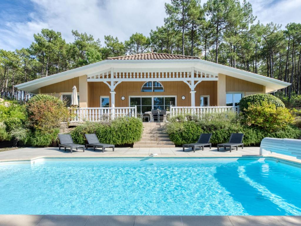 une maison avec une piscine devant une maison dans l'établissement Holiday Home Atlantic Green by Interhome, à Lacanau-Océan