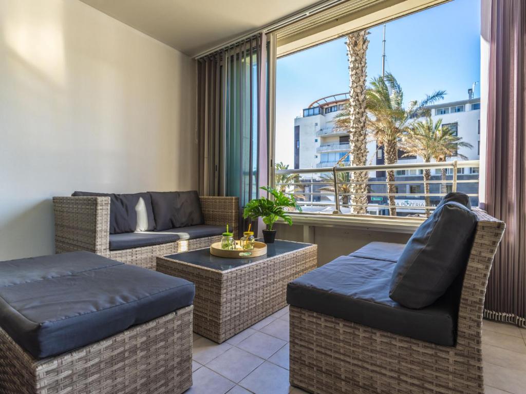 Elle comprend un salon meublé et une grande fenêtre. dans l'établissement Apartment Le Sunset-Cap Sud-26 by Interhome, au Cap d'Agde