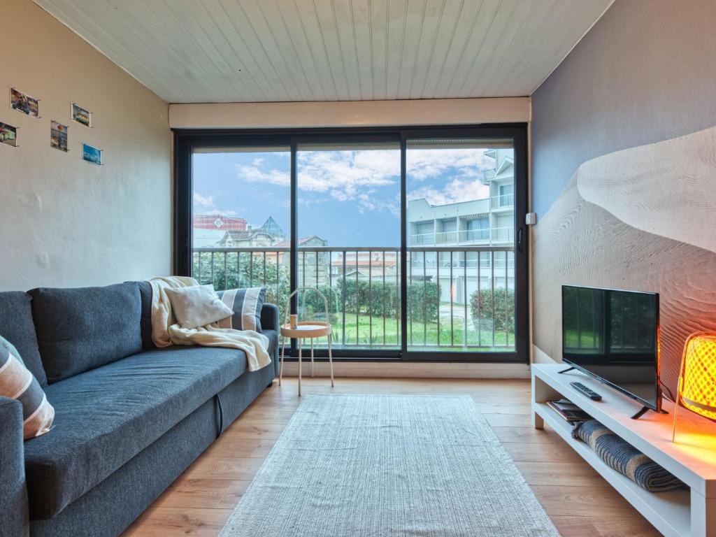 un salon avec un canapé et une grande fenêtre dans l'établissement Studio Les Sables d'Argent-10 by Interhome, à Lacanau-Océan
