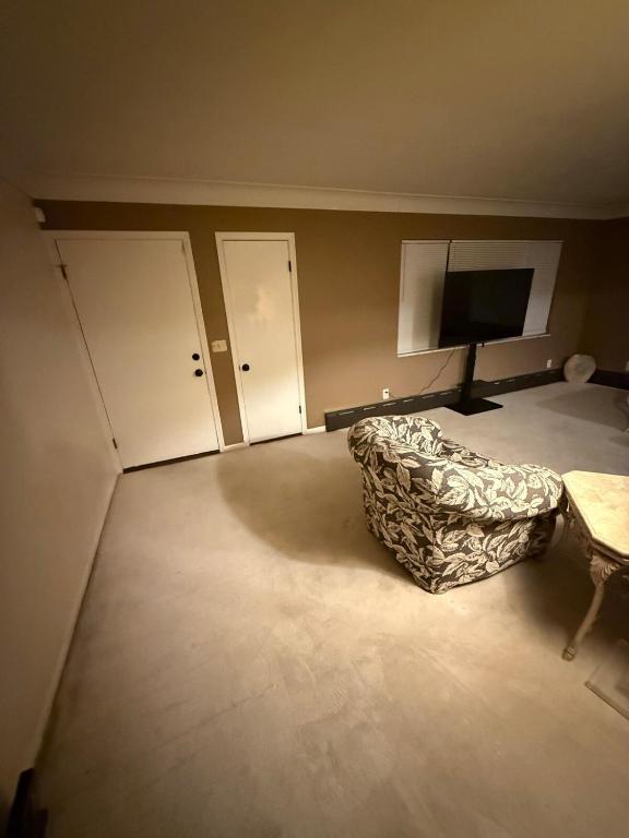 a living room with a couch and a tv in it at The Gather Grove in Toledo
