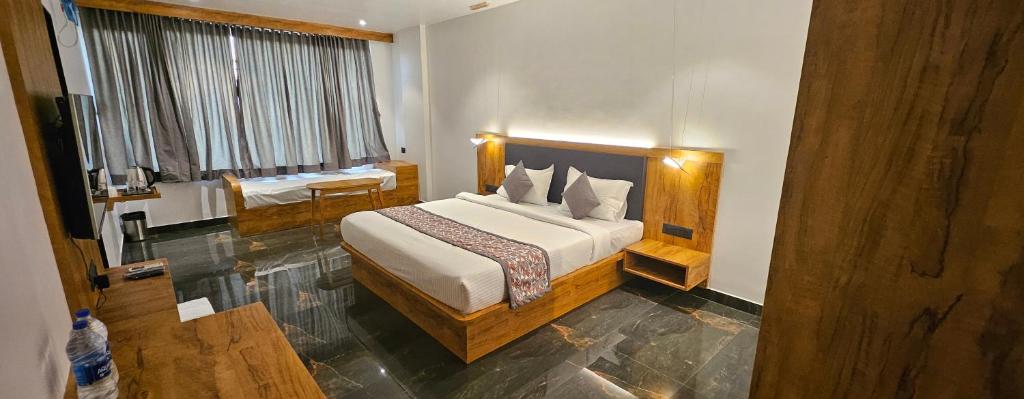 a bedroom with a large bed in a room at Vistara Residency in Navi Mumbai