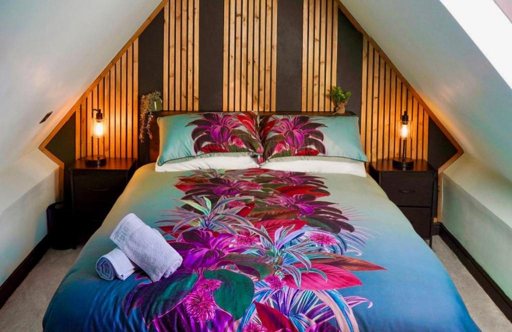 a bedroom with a large bed with a plant on it at The Snug King Bed in Portsmouth