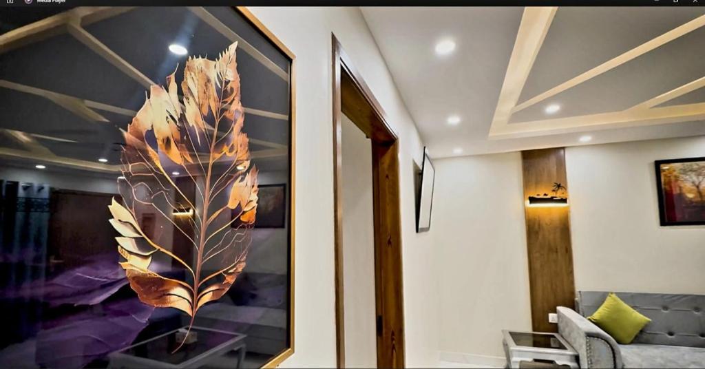 a room with a large feather painting on the wall at Royal Galaxy Hotel & Residence - Near Islamabad International Airport & Motorway in Islamabad
