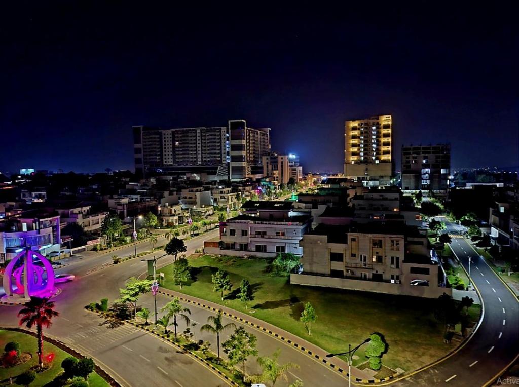 a view of a city at night with buildings at Royal Galaxy Hotel & Residence - Near Islamabad International Airport & Motorway in Islamabad