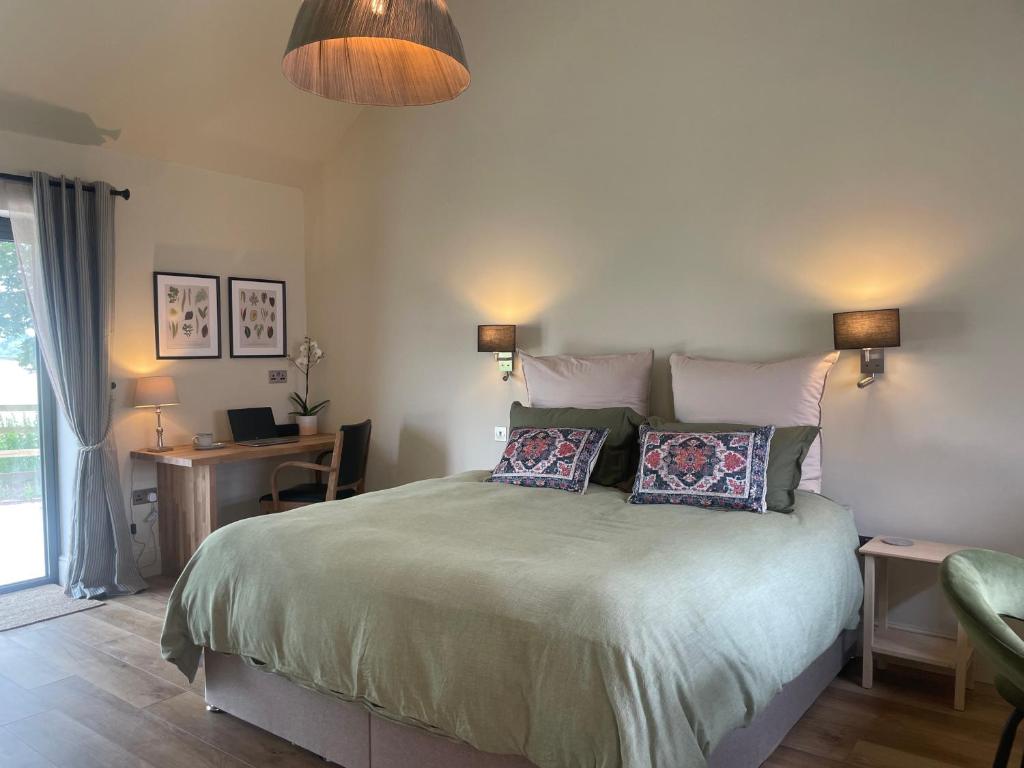 a bedroom with a bed with two pillows on it at Rural Retreat, 1 bed, sleeps 2 near Bleasby in Bleasby