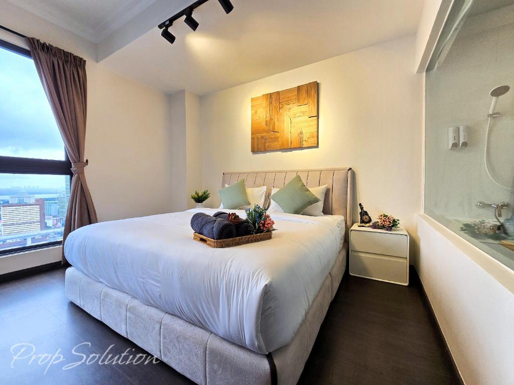 a bedroom with a large bed with a bath tub at Loft Suite Central City 2BR JB CIQ 7Pax in Johor Bahru