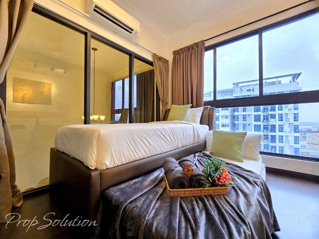 a bedroom with a bed with a tray of vegetables on it at Loft Suite Central City 2BR JB CIQ 7Pax in Johor Bahru