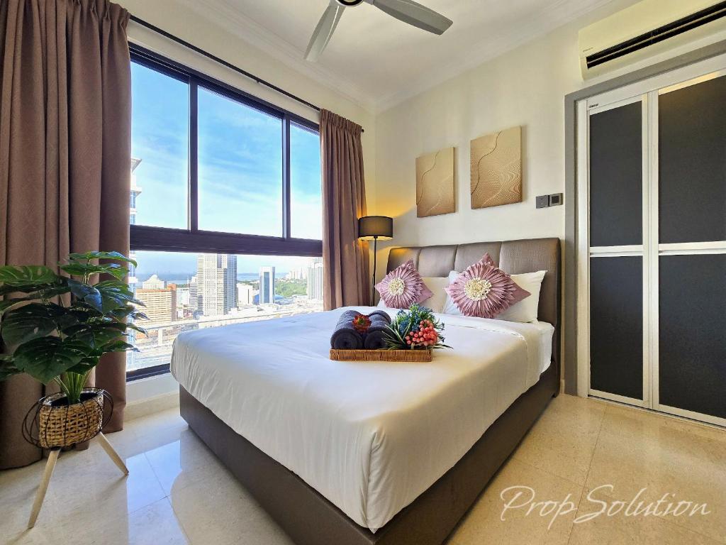 a bedroom with a large bed with fruit on it at Loft Suite Central City 2BR JB CIQ 7Pax in Johor Bahru