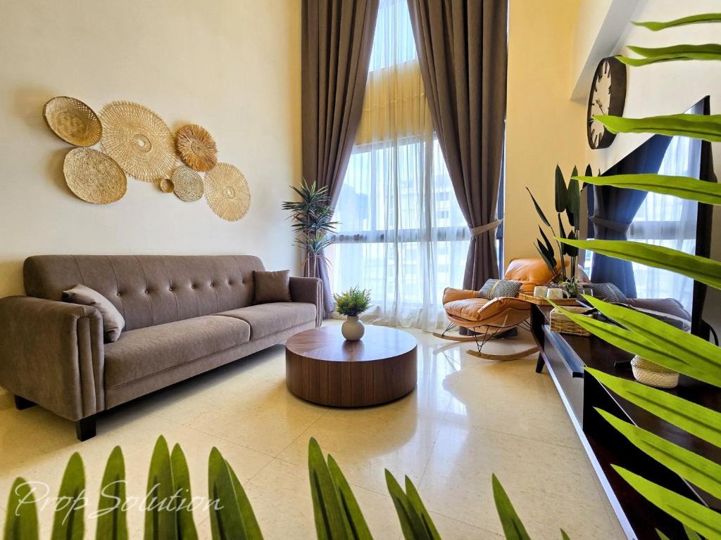 a living room with a couch and a table at Loft Suite Central City 2BR JB CIQ 7Pax in Johor Bahru