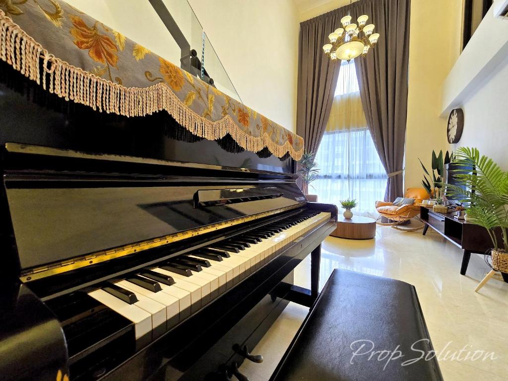 a piano sitting in a living room with a room with at Loft Suite Central City 2BR JB CIQ 7Pax in Johor Bahru
