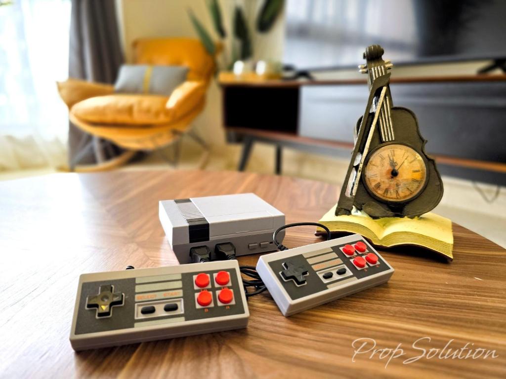 a table with an alarm clock and a clock radio at Loft Suite Central City 2BR JB CIQ 7Pax in Johor Bahru