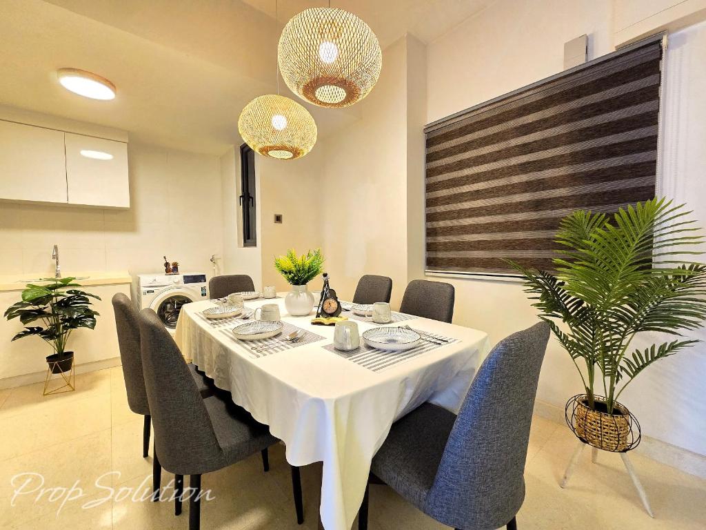 a dining room with a table and chairs at Loft Suite Central City 2BR JB CIQ 7Pax in Johor Bahru