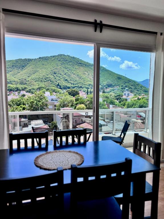 a table and chairs in front of a large window at Augusto Apart 3 in Salta