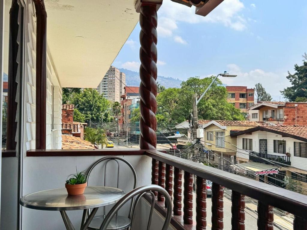 Un balcón con una mesa y vista a una ciudad. en Apartamento cerca a Estadio con balcon y 5 habitaciones, en Medellín